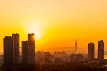 Fototapeta na wymiar Gold sunset of Seoul cityscapes with high rise office buildings and skyscrapers in Seoul city, Republic of Korea in winter blue sky and cloud