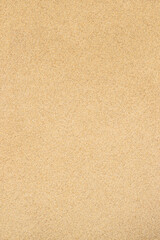 Fototapeta na wymiar Sand textured background. Fine-grained texture of sandy beach surface in yellow color