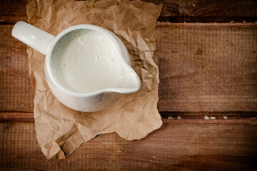 A jug of fresh milk on the table. 