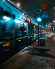 Tram at night in city while snowing