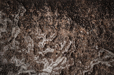 Rustic old damaged stone wall surface with heavy grunge texture
