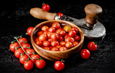 Tomatoes for marinating in a wooden plate.