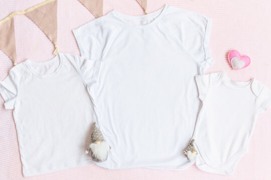 Valentines Day Mom And Kids Mockup White T-shirt And Baby Bodysuit Onesie With Gnomes And Heart On Pink Cover Background. Flatlay, Top View, Copyspace.