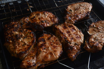 Pieces of fried pork meat. Barbecue. Delicious fried pork loin. Chunks of meat in close-up. Meat on coals.