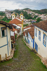 Fototapeta na wymiar Ouro Preto, MG, Brazil: street slope and ancient buildings of colonial city