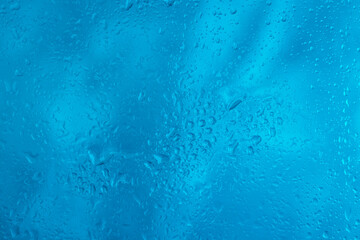 Drops of rain water droplets on glass