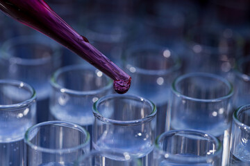 Pipette dropping fluid into test tube
