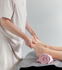 Close up hands doing a foot massage to a young girl