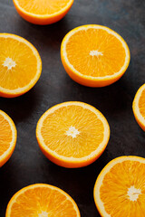 Fresh orange halves on a dark background. Juicy citrus fruits for making juice