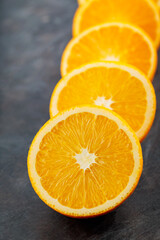 Fresh orange halves on a dark background. Juicy citrus fruits for making juice
