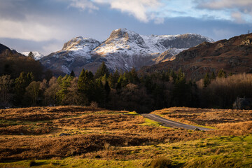 Winter in the Lake District, Cumbria, UK.  Langdale pikes catching the last of the sunlight during golden hour.  Beautiful UK scenery. 