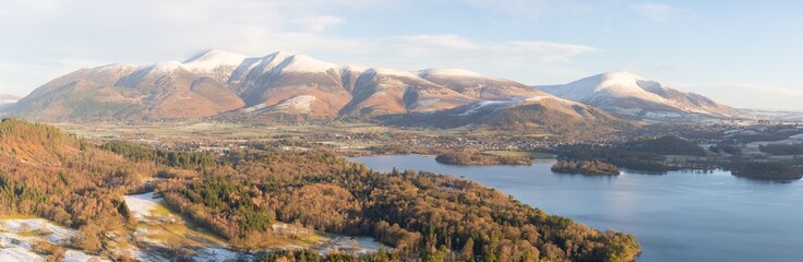 Landscape with Mountains and Lakes. Keswick beneath the towering snow-capped Skiddaw mountain.  High megapixel panorama. 