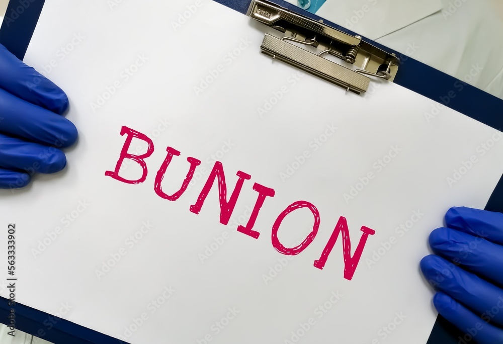 Wall mural Bunion medical term word with medical concepts on whiteboard in doctor hand.