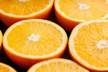 Orange halves on a wooden table. Orange slices close-up