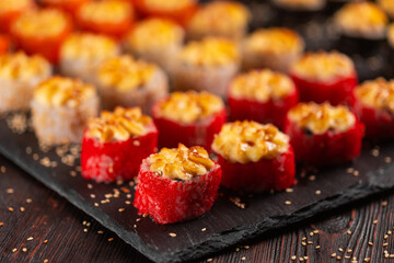 Japanese salmon sushi with spicy mayonnaise and tobiko caviar - Sushi menu norimaki and uramaki. Asian cuisine concept
