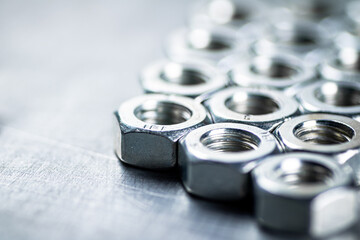 Working tool. Metal nuts on the table.  - obrazy, fototapety, plakaty