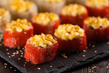 Japanese salmon sushi with spicy mayonnaise and tobiko caviar - Sushi menu norimaki and uramaki....