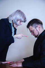 Angry strict executive, female ceo or team leader scolding employeer. Unprofessional behavior and team conflict concept. Vertical image.