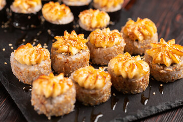 Japanese salmon sushi with spicy mayonnaise - Sushi menu norimaki and uramaki. Asian cuisine concept