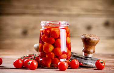 Pickled ripe tomatoes in a glass jar. 