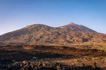 Sunset over volcano with lava flows on a sunny day