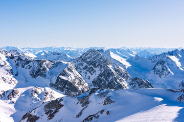 Expanse of snow-capped mountains on a sunny day