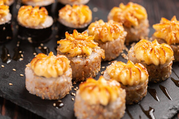 Japanese salmon sushi with spicy mayonnaise - Sushi menu norimaki and uramaki. Asian cuisine concept
