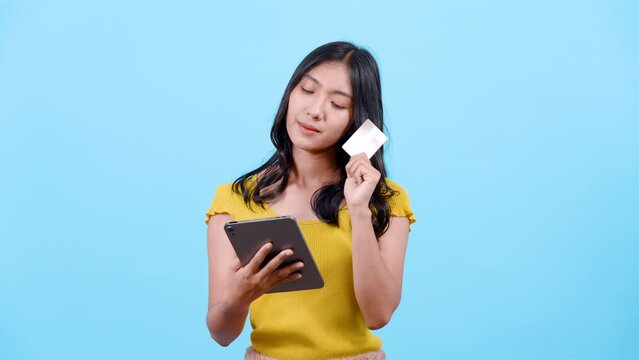 4K, portrait, long haired girl wearing shirt yellow tights, was holding laptop computer, Nodded for understanding, about credit card payments, online method, Isolated indoor studio on blue background.