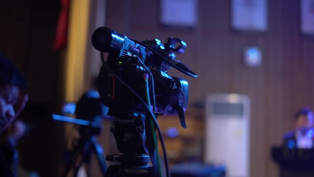 video camera in action on tripod stand