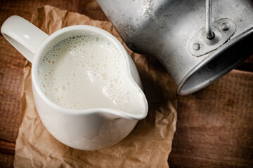 A jug of fresh milk on the table. 