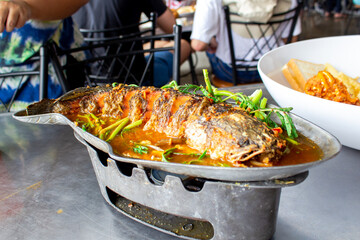 Fried snakehead fish in sour soup, Asian food style.