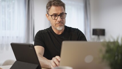 Man working with laptop in home office