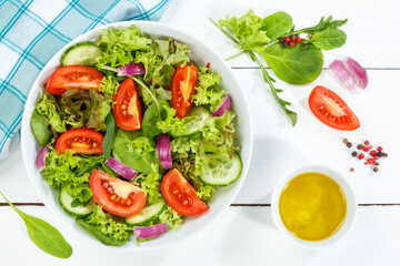 Mixed salad with fresh tomatoes healthy eating food from above on a wooden board