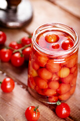 Fototapeta na wymiar Pickled ripe tomatoes in a glass jar. 