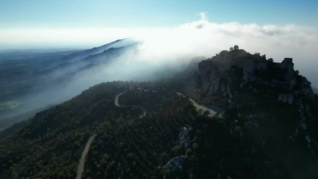 Kantara Kalesi (Cyprus, Kantara Castle). Beautiful video from the drone. Landscape. The high mountains of Cyprus. The sun's rays pass through the clouds. The drone flying through the clouds. The blue 