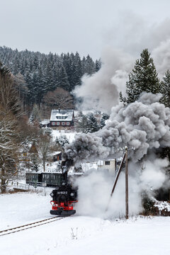 Pressnitztalbahn steam train locomotive railway in winter portrait format in Schmalzgrube, Germany