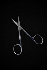 Manicure set on a black background. Scissors and nail tongs. Iron scissors and nail clippers.