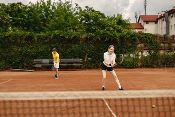 Tennis players playing a match on the court on a sunny day