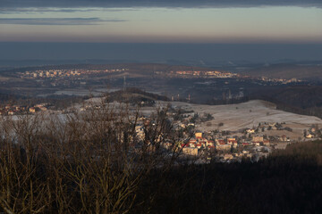 Obraz premium Panoramic view from the top of Dzikowiec Mountain, in Boguszow-Gorce near Walbrzych in Poland. Branches in foreground, selective focus. Popular viewing tower.
