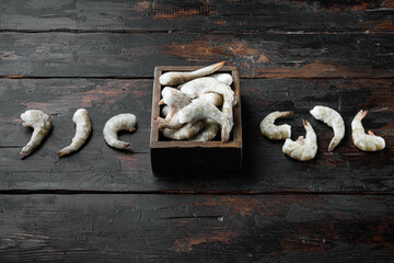 Frozen shell on Tiger Prawns or Asian tiger Shrimps, on old dark  wooden table , with copy space for text