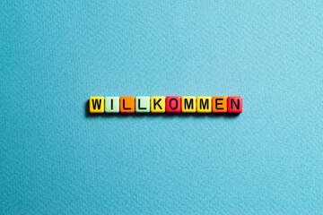 Willkommen - word concept on cubes
