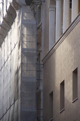 Building in the city under a scaffold