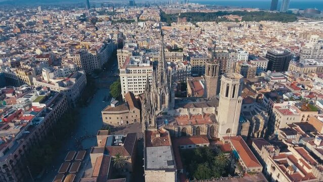 Top down footage of large church and surrounding buildings. Cathedral of Barcelona with gothic tower. Barcelona, Spain