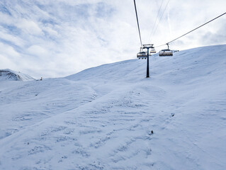 Fototapeta na wymiar Snow covered mountains and ski slopes, ski area Stoos