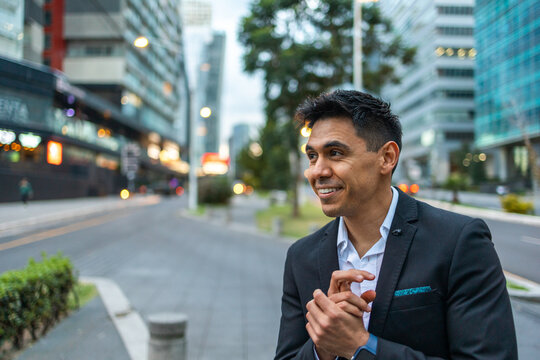 A Portrait Of A Young Latin Smiling, Happy, Successful Business Man Looking Away