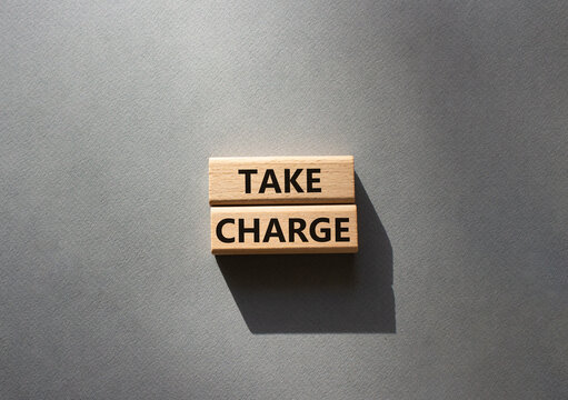 Take charge symbol. Wooden blocks with words Take charge. Beautiful grey background. Business and Take charge concept. Copy space.