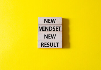 Mindset symbol. Wooden blocks with words New Mindset new Result. Beautiful yellow background....