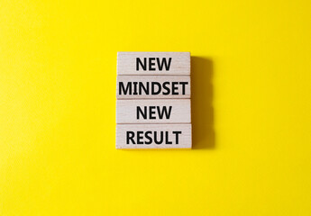 Mindset symbol. Wooden blocks with words New Mindset new Result. Beautiful yellow background. Business and New Mindset new Result concept. Copy space.