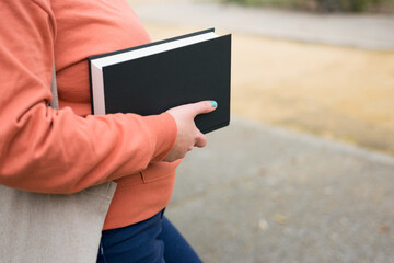 Close-up of a woman with a book in her hands