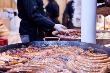 Closeup shot of sausages being cooked while being submerged in oil